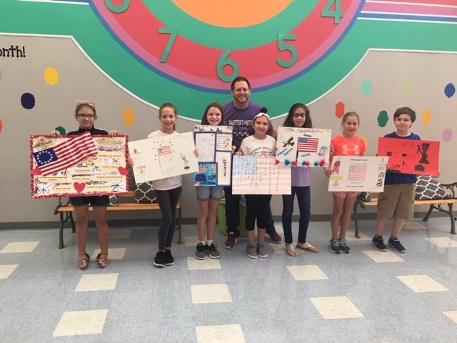  Principal of Pullen and fifth grade students holding their posters